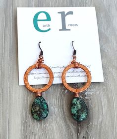 These boho style dangle earrings feature 1" copper hoops that have been hammered for texture and design.   They are finished with a tear drop shaped African turquoise gemstone. These earrings measure approximately 2.5" in length. They will ship in a gift box via USPS with tracking info provided. Artisan Copper Dangle Hoop Earrings, Bohemian Teardrop Copper Hoop Earrings, Hammered Copper Turquoise Jewelry, Turquoise Hammered Copper Jewelry, Bohemian Copper Earrings With Hammered Detail, Bohemian Hammered Copper Earrings, Copper And Turquoise, Jewelry Making Earrings, Wire Jewelry Designs