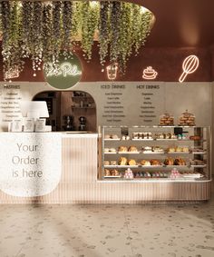 the interior of a bakery with plants hanging from the ceiling and baked goods on display