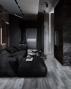 a living room filled with black furniture and wooden floors