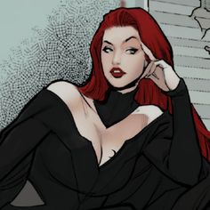 a woman with red hair is sitting down