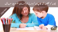 a woman sitting at a table with a child writing in front of her on paper