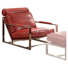 a red leather chair and footstool sitting next to each other