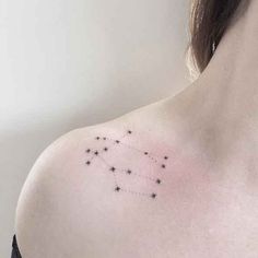 a woman's shoulder with small stars on it