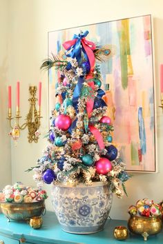 a decorated christmas tree sitting on top of a blue table