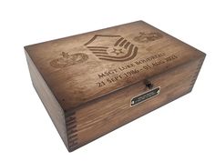 a wooden box with an army emblem on the lid is shown in front of a white background