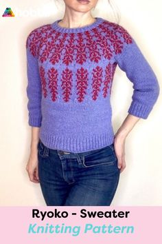 a woman wearing a purple sweater with red and blue designs on the back, standing in front of a white wall