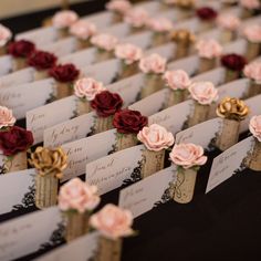 there are many place cards with flowers on them for guests to write in the envelopes