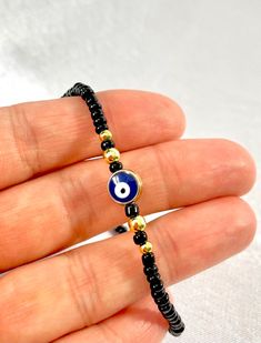 Trendy Evil Eye Jewelry, Trendy Adjustable Evil Eye Bracelet For Gift, Trendy Evil Eye Jewelry Gift, Trendy Beaded Evil Eye Bracelet As Gift, Trendy Beaded Evil Eye Bracelet For Gift, Trendy Evil Eye Bracelet With Round Beads As Gift, Black Resizable Jewelry, Black Evil Eye Round Beads Jewelry, Black Round Resizable Jewelry