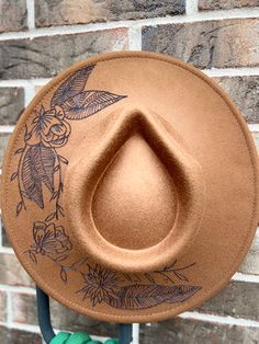 Celebrate your inner country girl with this unique Custom Rancher Hat. Hand burned flowers give it an eye-catching flair, perfect for a fashion-forward look. Show off your brown-eyed girl style in this one-of-a-kind hat. hand burned hat with floral details Western Style Brown Hat For Spring, Brown Fedora One Size Fits Most, Brown Felt Hat For Rodeo In Spring, Brown Felt Hat For Spring Rodeo, Brown Felt Hat For Spring Country Events, Spring Rodeo Brown Felt Hat, Vintage Brown Fedora For Spring, Brown Vintage Fedora For Spring, Country Style Brown Fedora For Spring