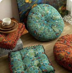 colorful cushions and ottomans are on the floor