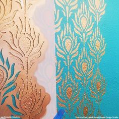 the wall paper is being stenciled with gold and blue paint on it's side