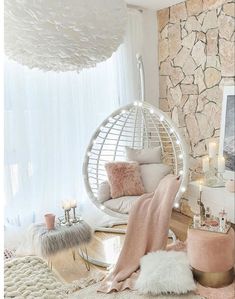 a room with a hammock hanging from the ceiling and pillows on the floor