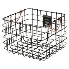 a wire basket with wires attached to the side and an electronic device in the middle