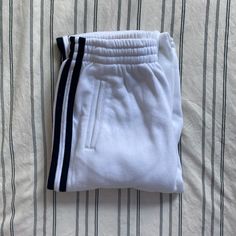 - Colors: White With Dark Navy Blue Stripes (Pretty Much Black) - Brand: Brandy Melville, John Galt Line - Size: Small - Never Worn (Nwot) - Very Soft And Comfy Sales Are Final | No Trades | No Refunds | Bundle To Save | Dm For Questions Or Offers White Athleisure Bottoms With Contrast Stripes, White Athleisure Sweatpants With Contrast Stripes, Sporty White Bottoms With Side Stripes, White Cotton Pants With Side Stripes, Fitted White Bottoms With Side Stripes, White Sporty Pants With Contrast Stripes, Sporty White Pants With Contrast Stripes, White Cotton Sweatpants With Side Stripes, White Sporty Pants With Three Stripes