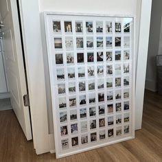 a white wall with pictures on it in front of a door and a window behind it