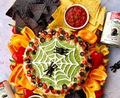 an assortment of mexican food including tortilla chips, salsa and guacamole