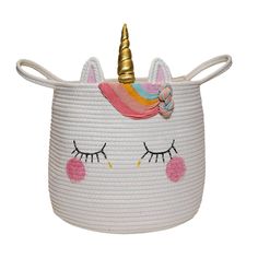 a white basket with a unicorn face and a gold horn