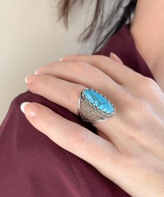 This 925 sterling silver cocktail ring with a stunning filigree pattern and a Turquoise gemstone exudes refinement and sophistication.The exquisite filigree art offers a lovely contrast, making it ideal for any formal occasion. This gorgeous accessory will enhance your look.The face of the ring is 0.80 inch long and 0.70 inch wide, and the Turquoise gemstone is 8x22 mm and has a cabochon oval shape.This ring is a work of art, with fine metal strands masterfully fashioned to create a lovely blend Classic Formal Turquoise Ring, Classic Turquoise Ring For Formal Occasions, Blue Bohemian Jewelry With Accent Stones, Turquoise Jewelry With Stone Setting For Anniversary, Anniversary Turquoise Jewelry With Stone Setting, Anniversary Turquoise Stone-set Jewelry, Turquoise Fine Jewelry Ring, Formal Turquoise Jewelry With Natural Stones, Turquoise Sterling Silver Jewelry With Accent Stones