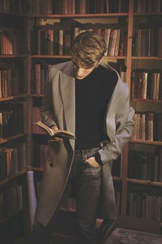 a man standing in front of a book shelf