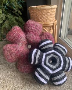 three crocheted teddy bears sitting on the floor next to a basket