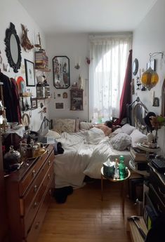 a messy bedroom with lots of clutter on the floor