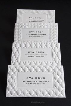 three white business cards on top of each other