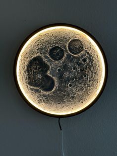 a round light hanging from the side of a wall with bubbles on it's surface