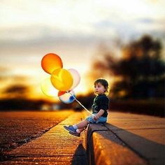 a little boy sitting on the side of a road holding onto some balloons with a quote about stop stressing over it, just let it be everything will be fine