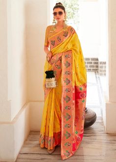 Turn heads in the captivating Yellow Paithani Silk Saree, a timeless embodiment of Indian tradition. This exquisite saree is adorned with delicate motifs, exuding an aura of refinement and grandeur. The intricately woven traditional Paithani Border and Pallu add a touch of opulence, lending a regal and ethereal look. Elevate your ethnic wardrobe and experience the joy of draping a saree that celebrates Indian elegance and femininity. Occasion: Wedding Wear, Party Wear, Festive Wear, Engagement W Yellow Paithani Saree, Yellow Paithani, Yellow Silk Saree, Haldi Wear, Colored Weave, Haldi Outfits, Paithani Saree, Lehenga Style, Half Sleeve Blouse