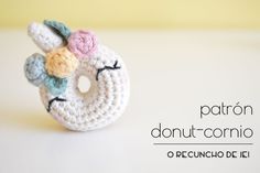 a crocheted donut with flowers on it sitting on top of a table