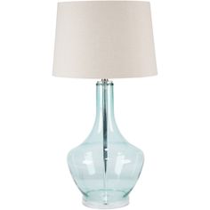 a blue glass lamp with a white shade on it's base and a beige linen lampshade