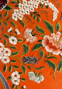 an orange cloth with flowers and butterflies on it