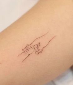 a close up of a person's arm with a tattoo on the left side