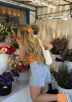 a woman is working in a flower shop