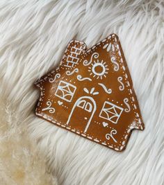 a cookie shaped like a house on top of white fur