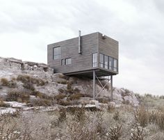 a house on top of a hill surrounded by trees