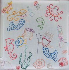 a white tray with various colored drawings on the front and side of it, including sea animals