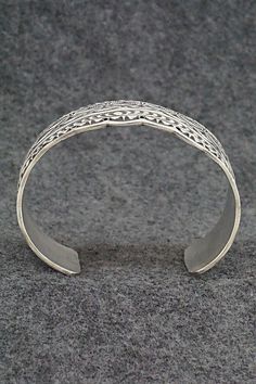 This stunning sterling silver bracelet was made by Navajo silversmith Leonard Maloney. The back is signed Maloney and stamped sterling.Size: 6" (will fit up to a 6 3/8" wrist)Gap: 1 3/8"Width: 1 3/4"Free shipping on all orders! We ship with USPS and always include tracking. All orders ship within a day of payment.Returns are accepted up to 30 days after you receive your order. Just send us a message. Our shop offers cash back or store credit. The item must be returned in new condition. Antique Silver Adjustable Cuff Bracelet With Intricate Design, Adjustable Antique Silver Cuff Bracelet With Intricate Design, Traditional Sterling Silver Nickel-free Bracelet, Traditional Nickel-free Sterling Silver Bracelet, Sterling Silver Cuff Bracelet With Intricate Design, Ceremonial Sterling Silver Cuff Bracelet With Oxidized Finish, Antique Silver Sterling Silver Cuff Bangle, Antique Silver Sterling Silver Cuff Bracelet, Silver Sterling Etched Cuff Bracelet