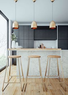 three stools in front of an island with marble counter top and black cabinets, along with two large windows