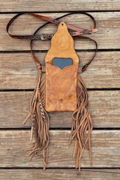 a brown leather case sitting on top of a wooden table