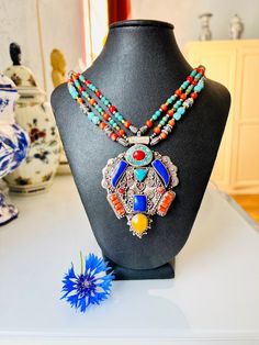 A necklace from Nepal captivates with its brightness and originality. Both the pendant and the chains are made of natural turquoise, coral, copal and lapis lazuli beads. The size of the pendant is 6 by 8 cm, the length of the necklace is 46 cm. Clasp-hook. Excellent condition. SHIPPING *This product will be sent to you in a gift package. *Our store provides free shipping to any country in the world. Delivery will be done with tracking. RETURN POLICY * I gladly accept returns & exchanges. Contact Bohemian Pendant Necklaces For Festivals, Festival Turquoise Pendant Beaded Necklaces, Festival Turquoise Necklaces With Colorful Beads, Traditional Turquoise Necklaces For Festivals, Bohemian Pendant Necklace With Beaded Chain, Bohemian Turquoise Beaded Necklaces For Festivals, Turquoise Bohemian Beaded Necklaces For Festivals, Multicolor Natural Stones Necklace For Festivals, Silver Bohemian Turquoise Necklace For Festivals