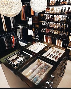 an open drawer in the middle of a closet filled with lots of shoes and bracelets