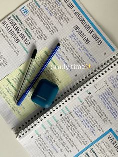 a blue pen sitting on top of a paper next to a calculator