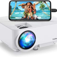 a white projector sitting on top of a table next to a phone and camera