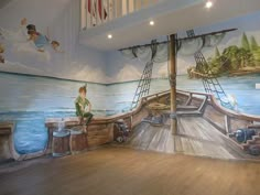 there is a mural painted on the wall in this children's room that features a pirate ship