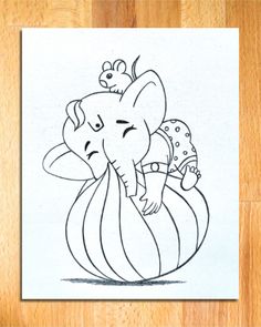 an elephant is sitting on top of a ball