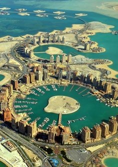 an aerial view of a large city with lots of water