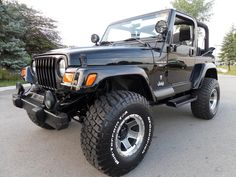 a black jeep is parked on the street