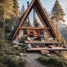 a - frame cabin in the mountains with deck and seating area