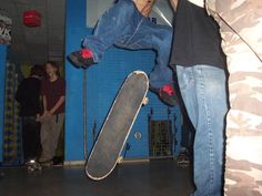 a man doing a trick on a skateboard in the air with his feet off the ground